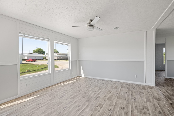 Open living room with large windows inside the new double-wide