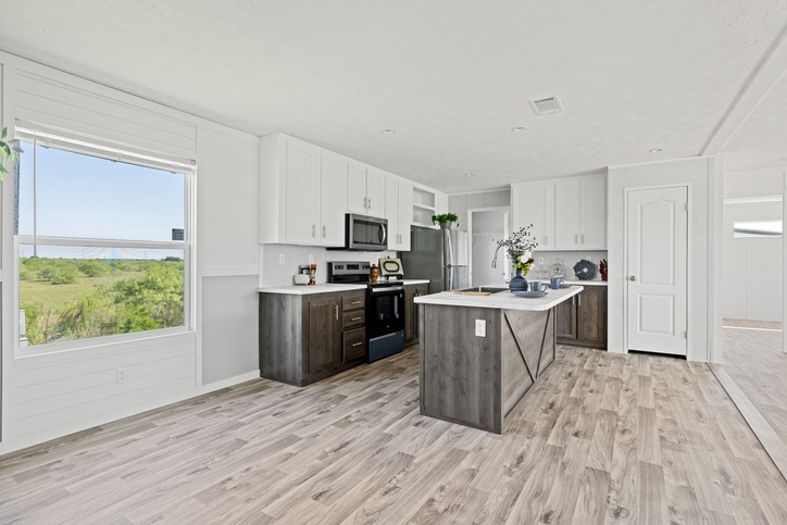 Island kitchen with stainless appliances inside the new double-wide