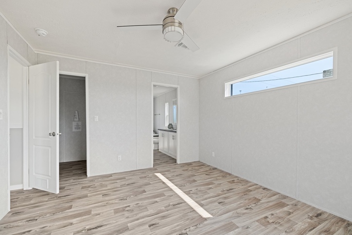 Bedroom with ceiling fan inside the new double-wide
