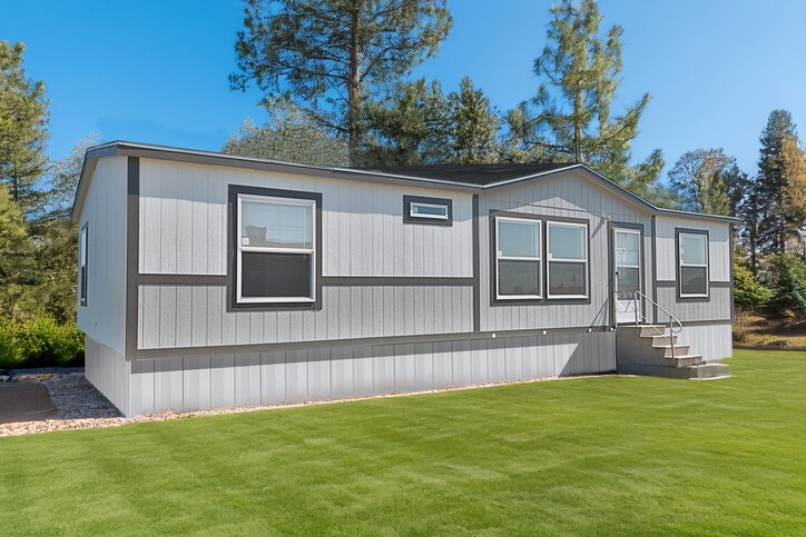 Exterior of the new 3-bedroom double-wide set on a green Texas lawn