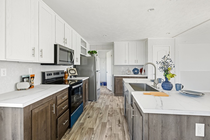 Island kitchen with stainless appliances inside the new double-wide
